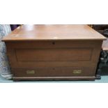 A large Victorian pine blanket chest with hinged top concealing internal candle store with two short