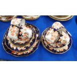 A Royal Crown Derby teaset, pattern number 9259, comprising six cups, saucers, plates and a cake