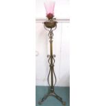 A 19th century brass adjustable oil standard lamp on tripod base, 158cm high Condition Report: