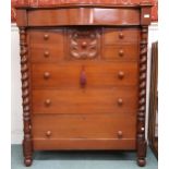 A large late Victorian mahogany serpentine front chest of drawers with long frieze drawer over
