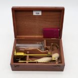 A lacquered brass specific gravity balance scale, in fitted wooden case, including a small mercury