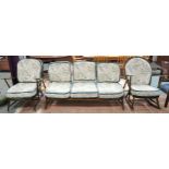 A mid 20th century Ercol elm and beech framed three piece suite comprising three seater settee, 78cm