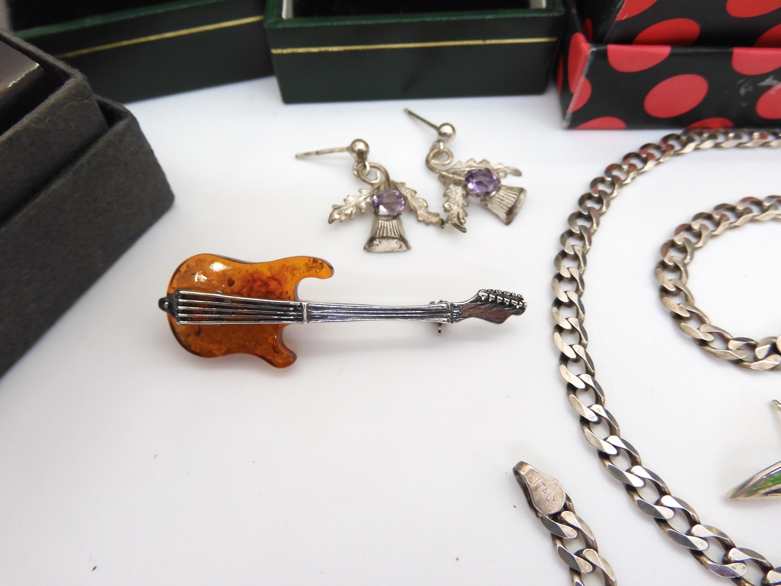 A silver scarf brooch by Ola Gorie, a pair of silver and enamel Ortak earrings, an amber guitar - Image 4 of 8
