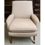 A mid 20th century grey upholstered armchair on shaped teak supports, 79cm high x 70cm wide x 80cm