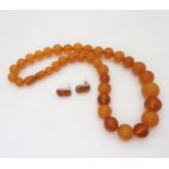 A string of butterscotch and honey amber coloured beads, largest bead approx 17mm, weight 46.4gms,