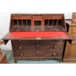 A late Georgian mahogany fall front writing bureau with fitted writing compartment over four long