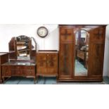An early 20th century mahogany three piece bedroom suite comprising three doored wardrobe, 198cm