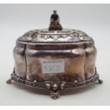 A silver plated tea caddy, of bombe form, the finial modelled as a snake charmer, with bands of