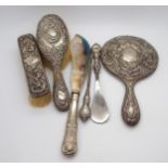 A matched silver dressing set, including a mirror, hair brush, clothes brush, shoe horn and