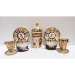 A pair of Paragon cups and saucers decorated with flowers, a Davenport lidded jar and a pair of