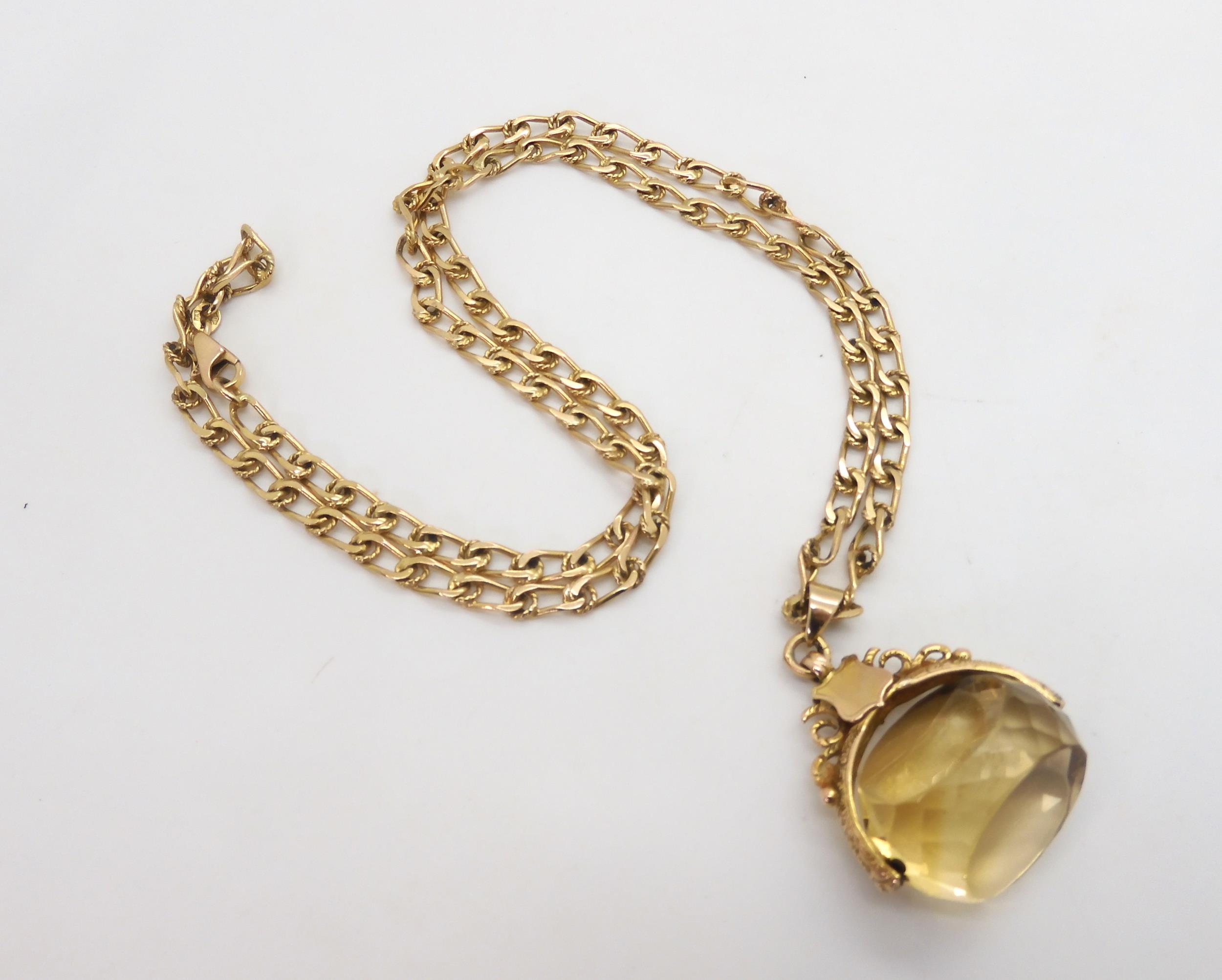 A 9ct citrine fob seal hallmarked Birmingham 1915, on a long 9ct gold fancy chain, length 60cm,