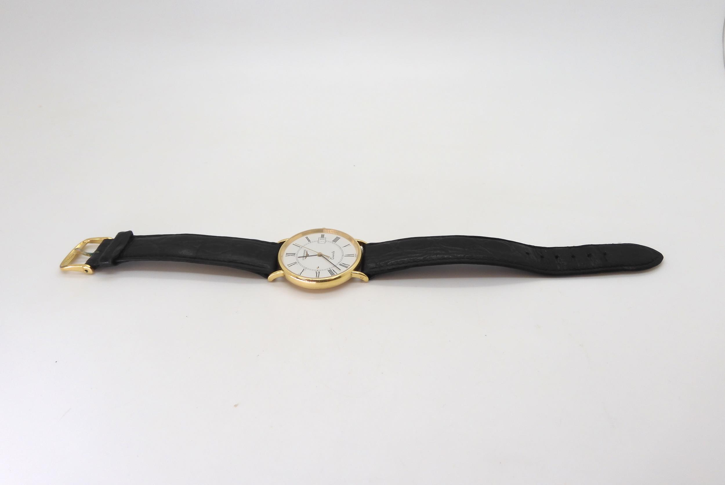 An 18k gold Longines Quartz watch, with a black leather strap, with gold plated Longines buckle, - Image 2 of 3