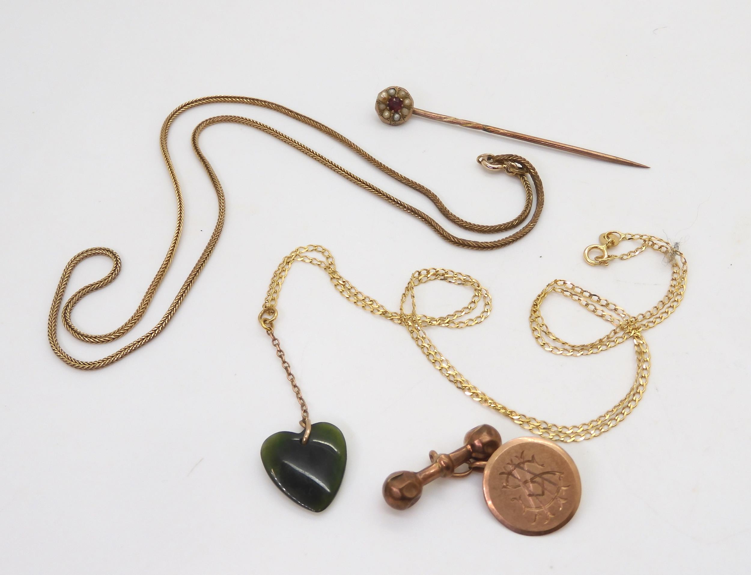 A 9ct gold herringbone chain, length 44cm, a curb chain with a heart shaped green hardstone pendant,