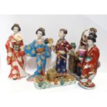 A Japanese candleholder, modelled as a Geisha and four other ceramic Geisha figures Condition