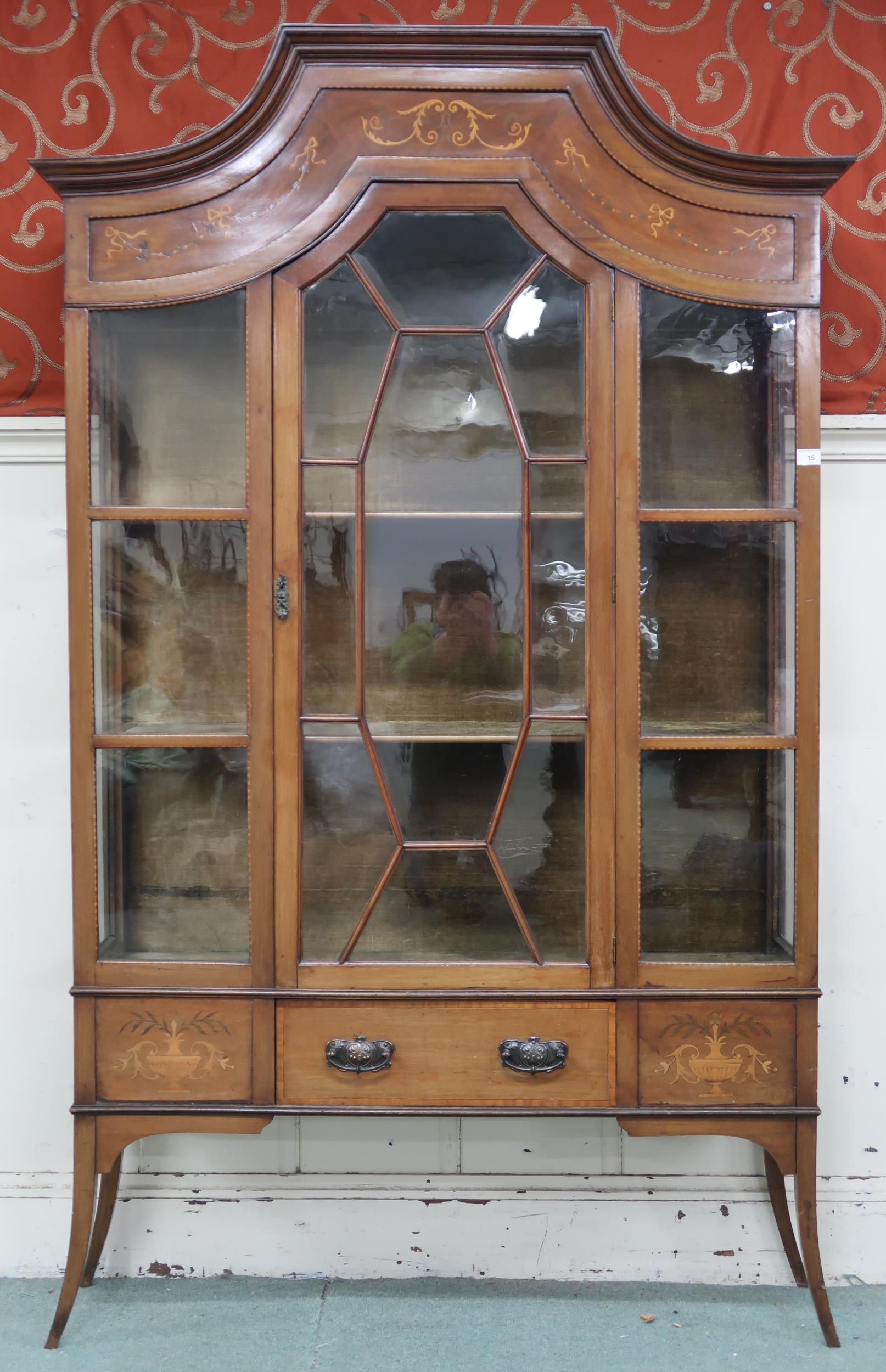 A late Victorian mahogany and satinwood inlaid display cabinet with single central glazed door