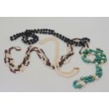 A collection of gemstone beads with gold  and yellow metal clasps and accent beads, to include