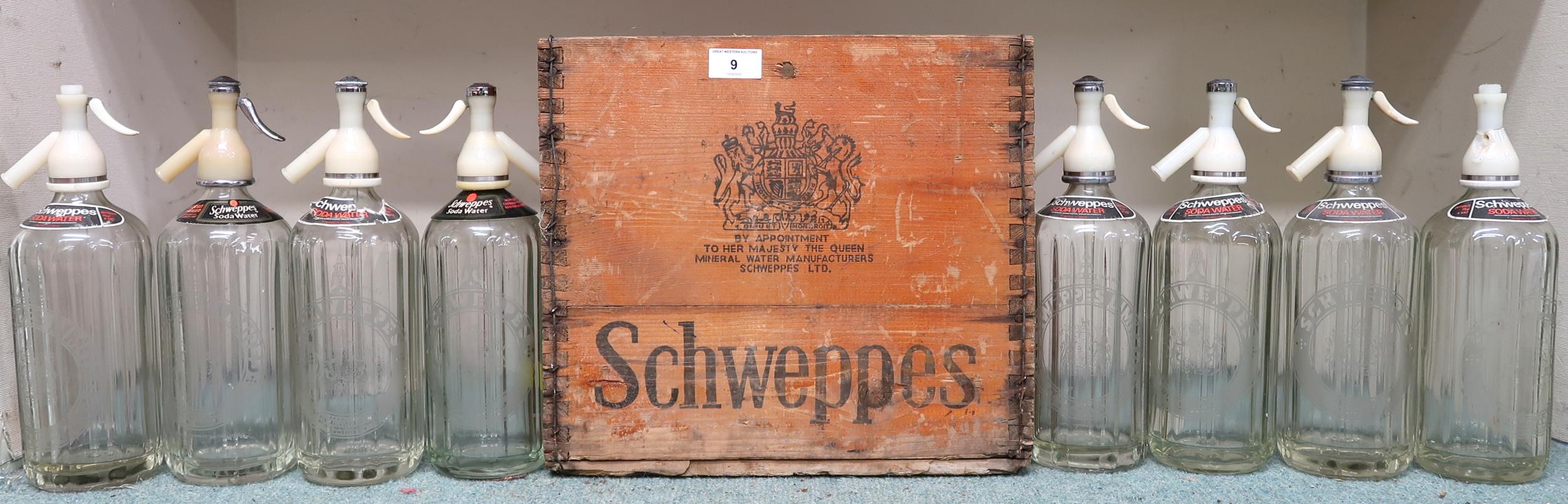 A lot to include eight Schweppes brand glass soda syphon bottles and a Schweppes six division