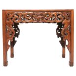 A 20th century Oriental hardwood altar table with extensively carved pierced friezes over square