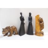 Two carved black forest bears, one modelled climbing a trunk, and two Royal Doulton figures