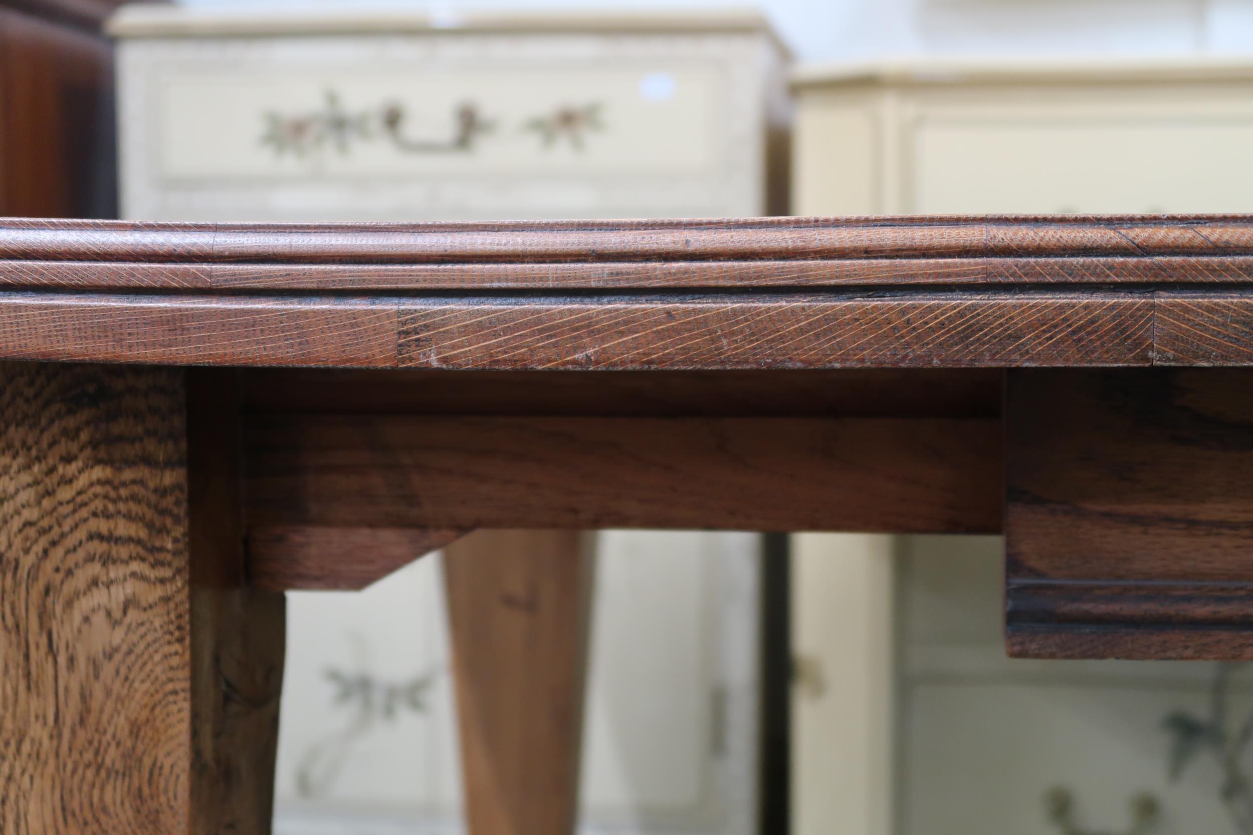 A late Victorian oak arts and crafts style wind out extending dining table with two leaves (one - Image 9 of 9