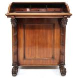 A Victorian mahogany Davenport writing desk with cylinder top writing compartment over pair of