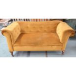 A Victorian mustard button upholstered drop end sofa on shaped supports terminating in ceramic