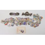 An extensive silver and enamel place name charm bracelet, with two Victorian white metal brooches