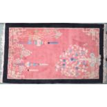 A lot to contain pink ground Oriental style rug with scenic pattern and black border, 213cm long x