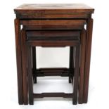 A 19th century Chinese hardwood nest of three tables with rectangular tops on shaped square supports