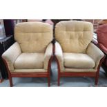 A pair of Ercol elm and beech framed armchairs with yellow upholstered cushions, 100cm high x 79cm