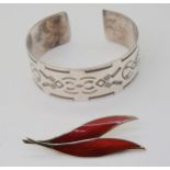 A silver Georg Jensen bangle, pattern number 64, together with a silver gilt red leaf brooch by