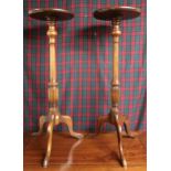 A pair of 20th century mahogany torchiere stands on tripod bases, 92cm high x 31cm diameter (2)