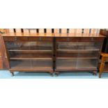 A pair of 20th century stained teak bookcases with pair of drawers over glass sliding doors, 90cm