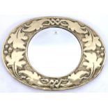 An early 20th century British brass framed oval wall mirror with frame embossed foliate design