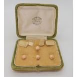 A boxed set of cufflinks hallmarked Chester 1949, and four 9ct shirt studs with floral engraving,