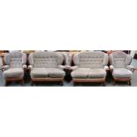 A 20th century beech framed Ercol style four piece suite comprising two two seater sofas, 102cm high