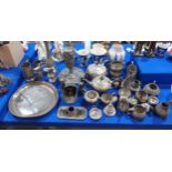 A large collection of pewter including a stag head stirrup cup, a Swatow tray, teasets, jugs etc