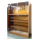 A mid 20th century teak glass sliding door bookcase, 114cm high x 76cm wide x 31cm deep Condition