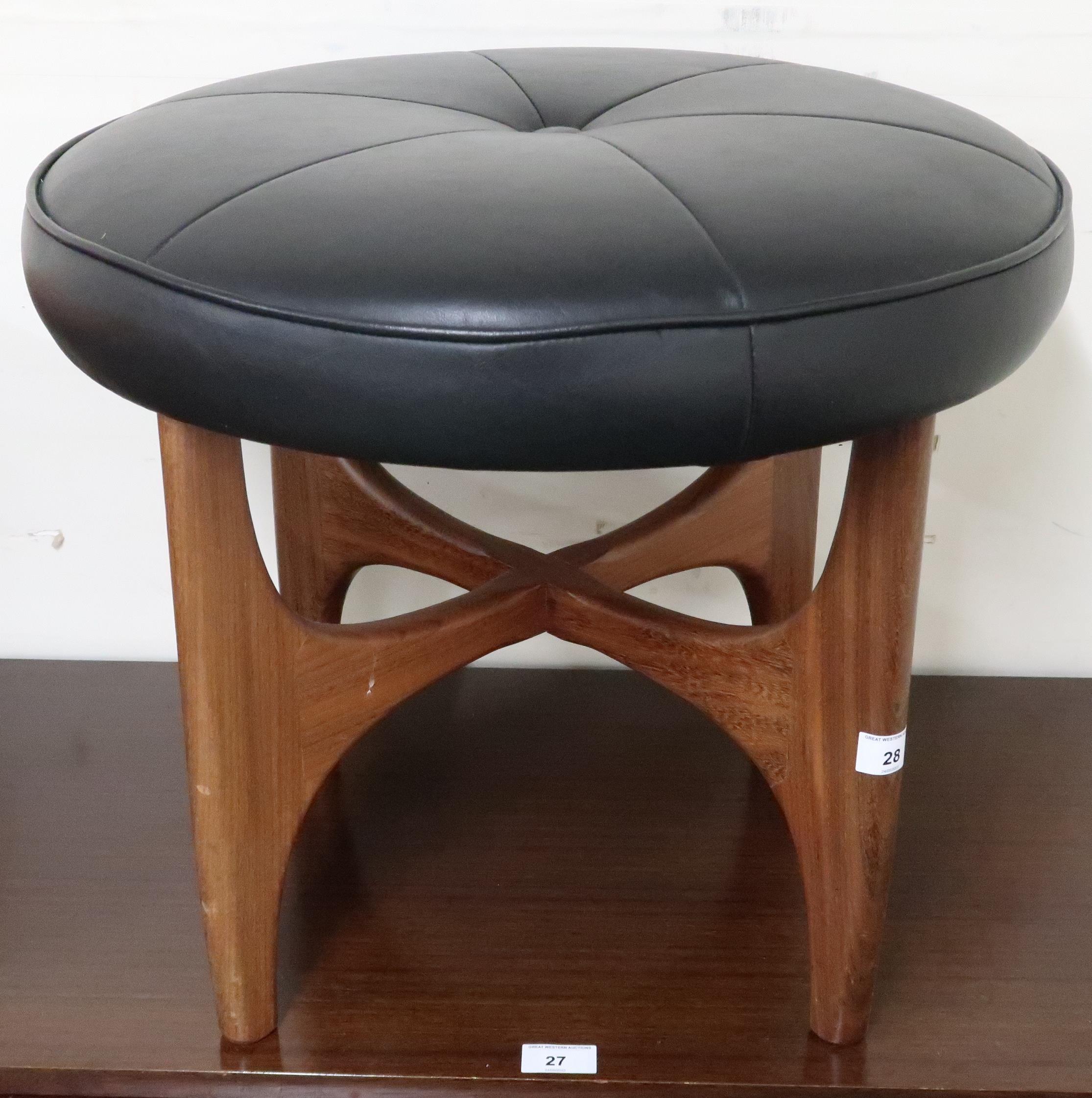 A mid 20th century teak G Plan Fresco stool with black vinyl upholstered seat, 44cm high x 53cm