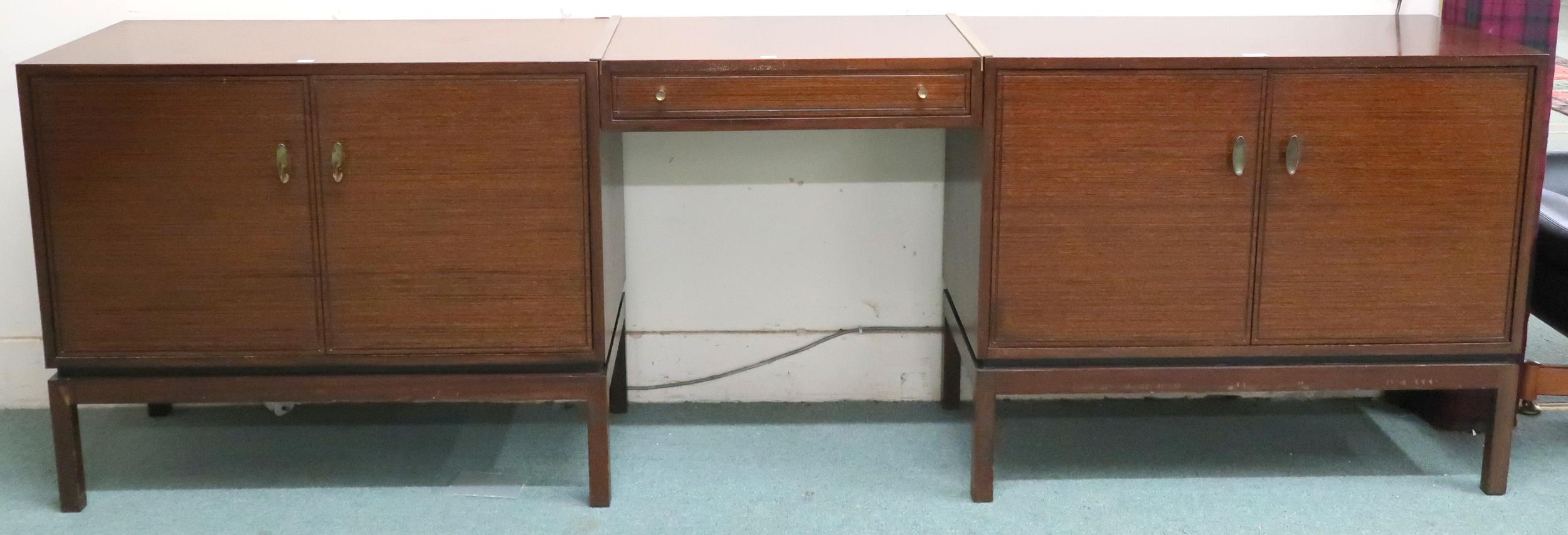 A mid 20th century stained teak Greaves and Thomas pair of two door cabinets joined by single