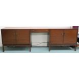 A mid 20th century stained teak Greaves and Thomas pair of two door cabinets joined by single