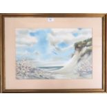 A framed seaside watercolour signed Foster H Nystrom, depicting a sandy cliff and seagulls in flight