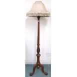 An early 20th century mahogany standard lamp with carved reeded column upright on tripod base