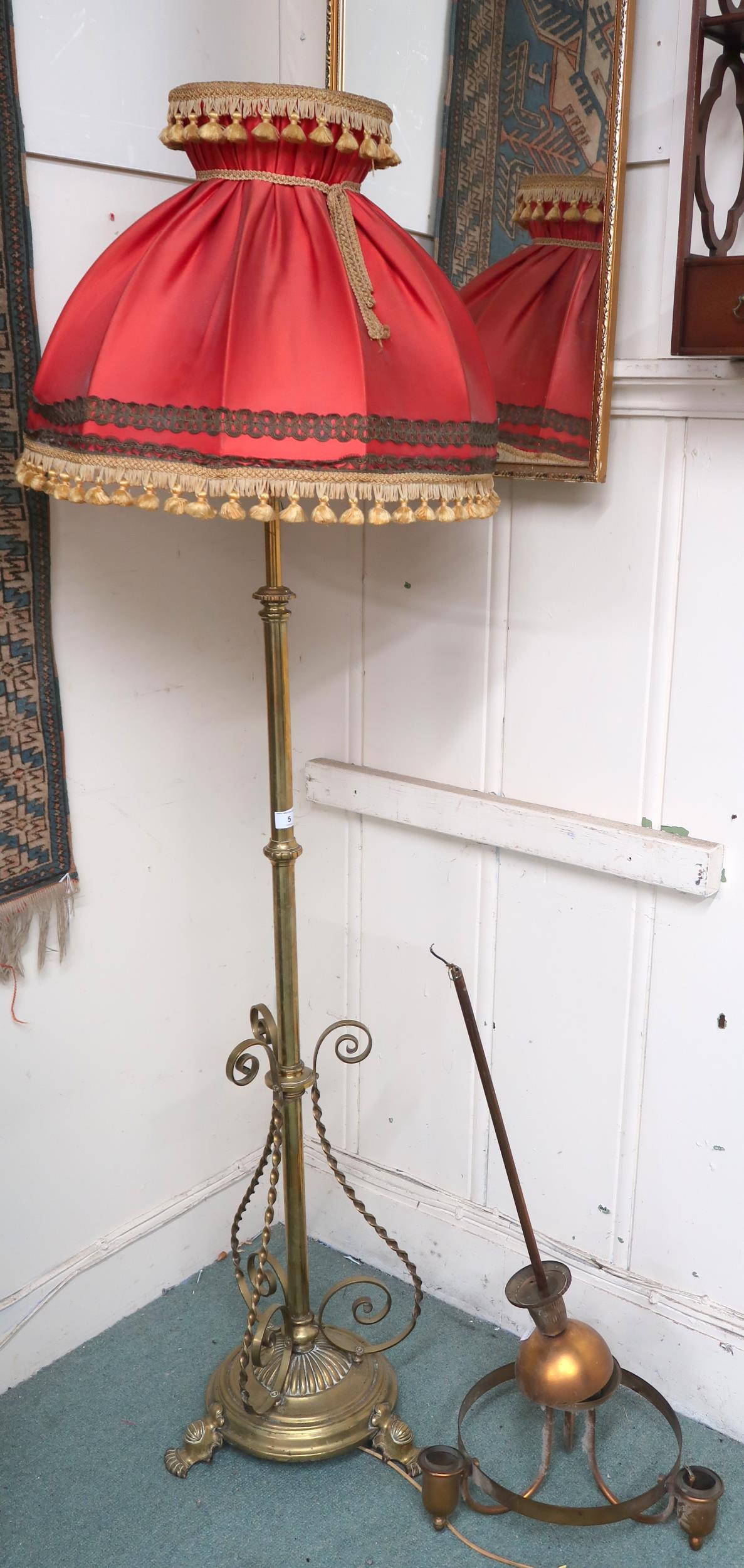 A 19th century brass adjustable standard lamp converted to electric with scroll decoration to