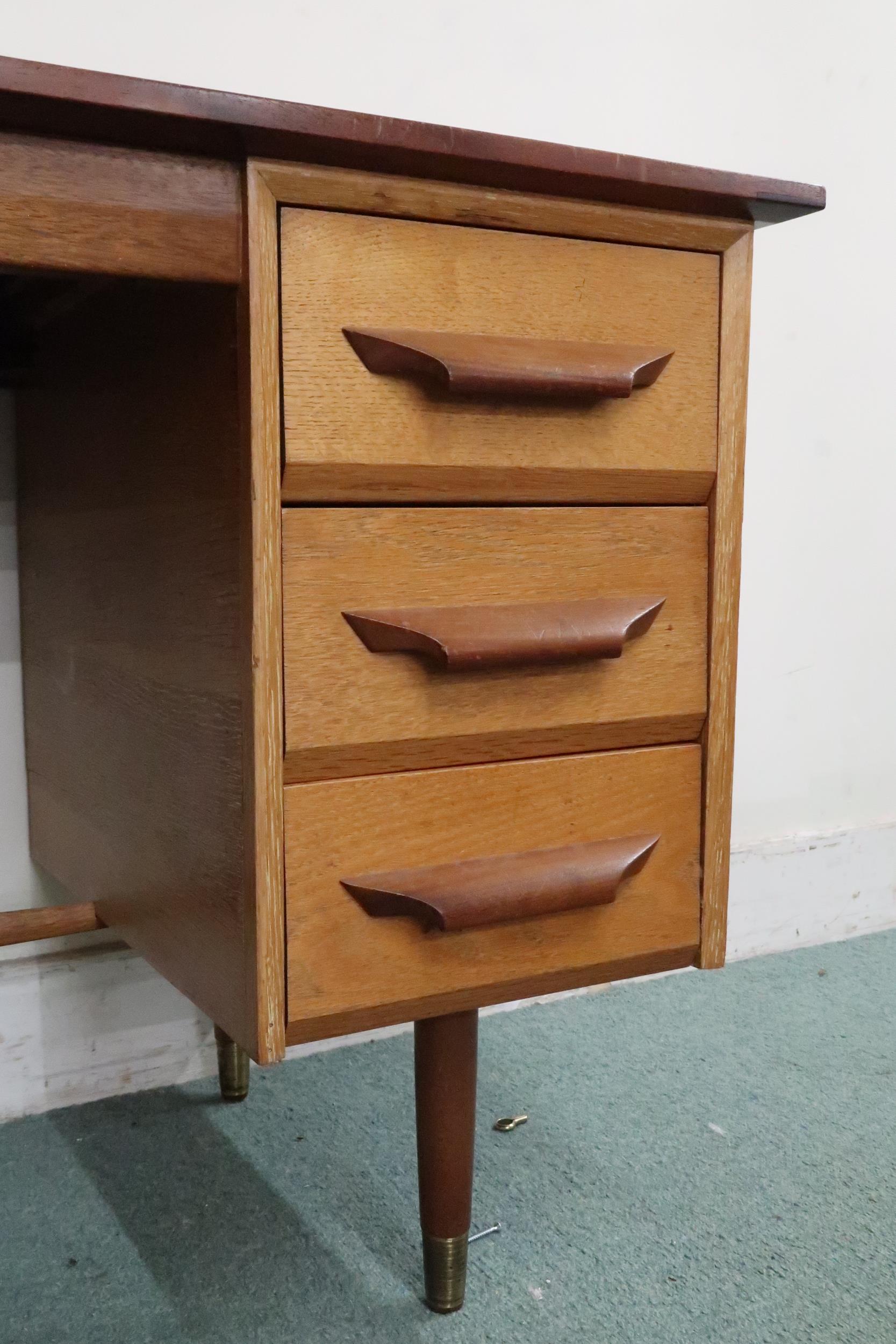 A mid 20th century teak desk with red vinyl skiver over bank of three drawers on tapering - Image 2 of 6