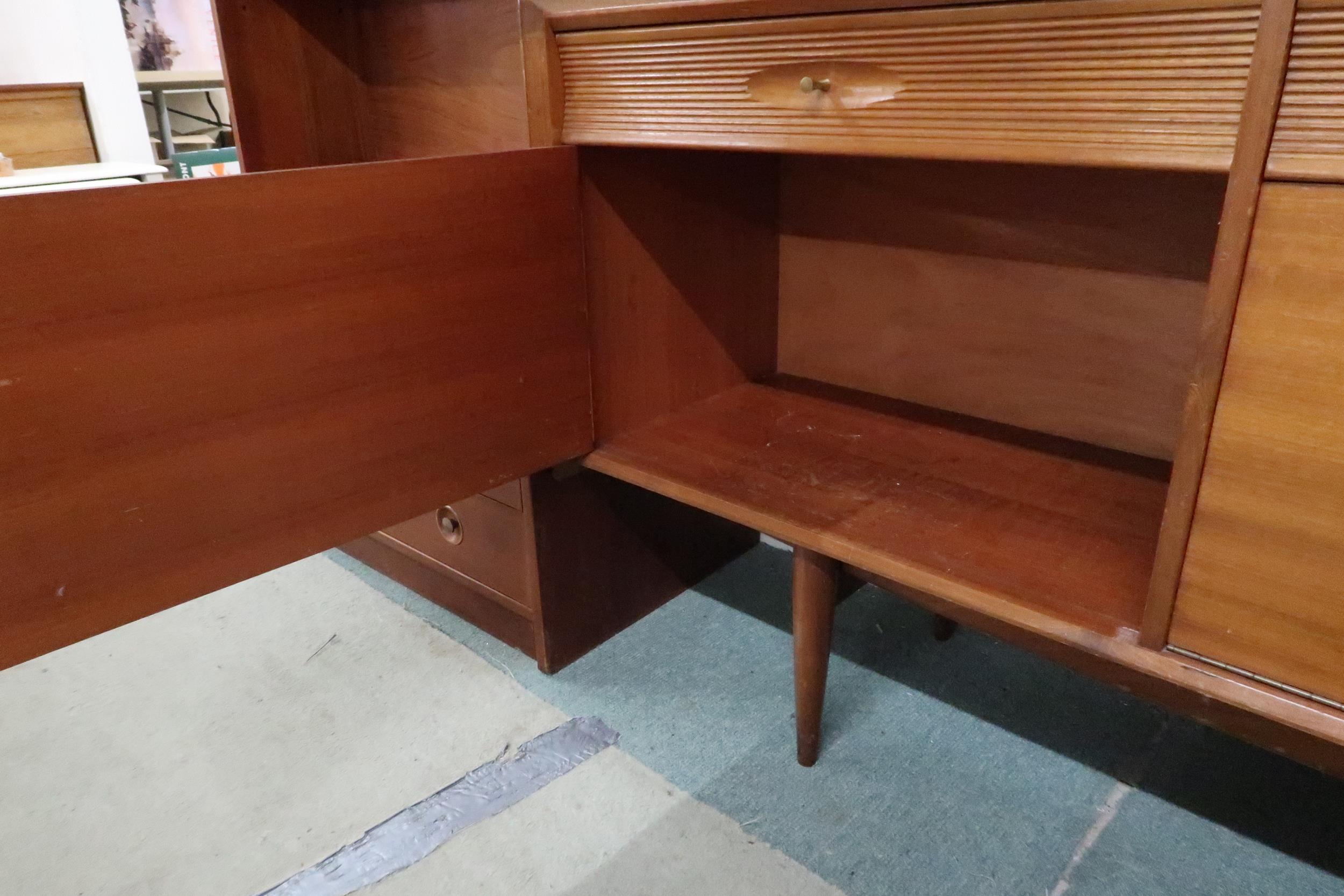 A mid 20th century teak sideboard with three drawers over central fall front compartment flanked - Image 6 of 8