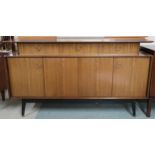 A mid 20th century G Plan E Gomme sideboard with three drawers pair of concertina doors on shaped