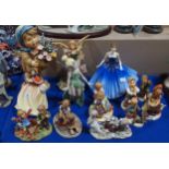 A large resin Hummel figure, three others smaller, porcelain Hummels including Sunday Stroll, two