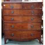 A Victorian mahogany bow front chest of drawers with two short over four long drawers on out swept