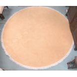 A large peach ground circular rug, 274cm diameter Condition Report:Available upon request